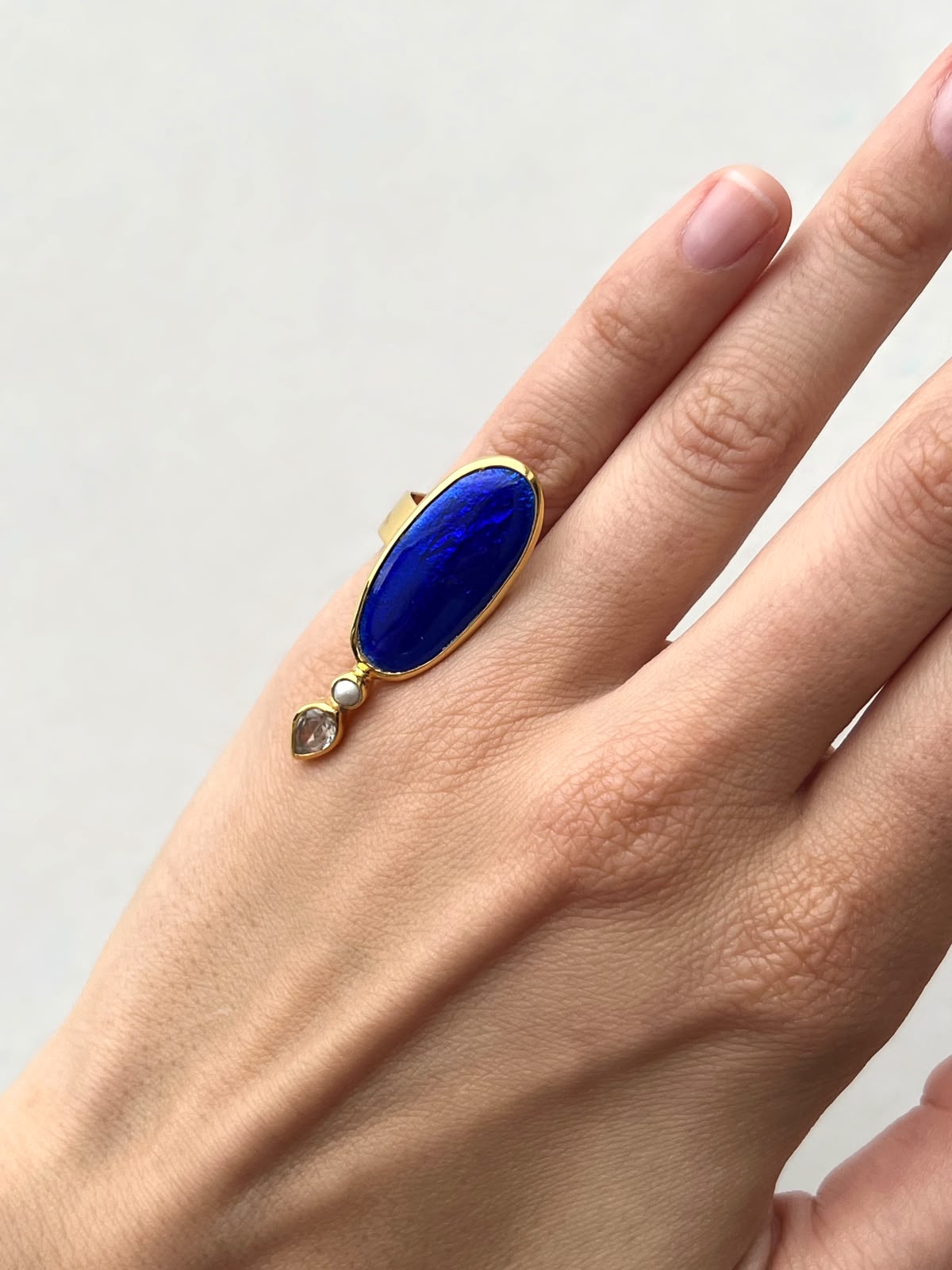 Blue oval ring with small Peral and stone