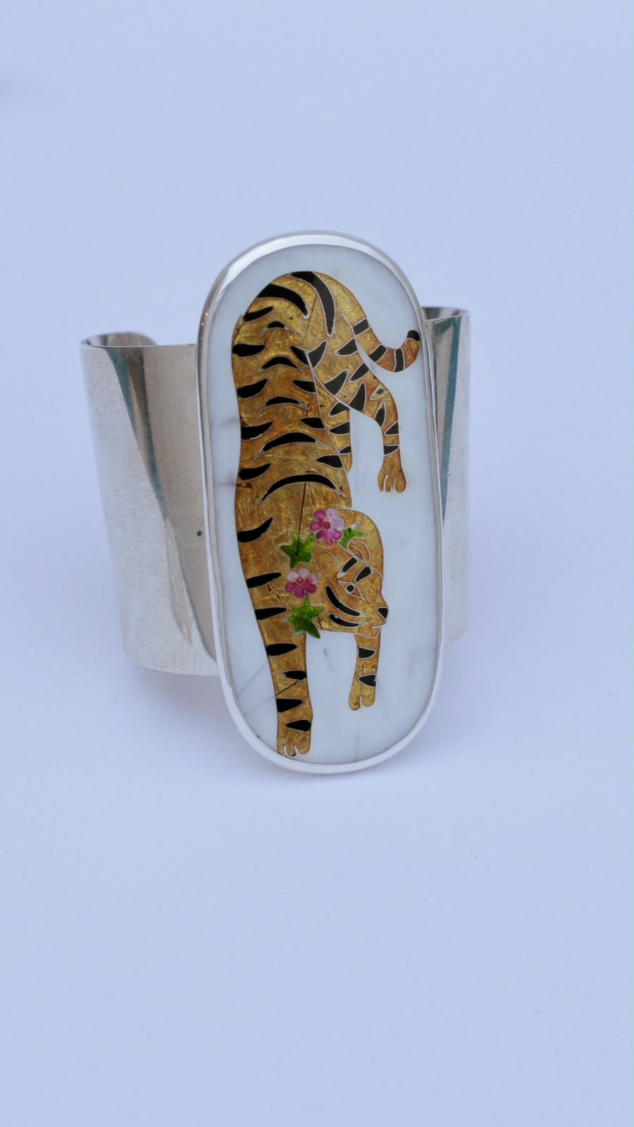 white silver bracelet with yellow tiger on it
