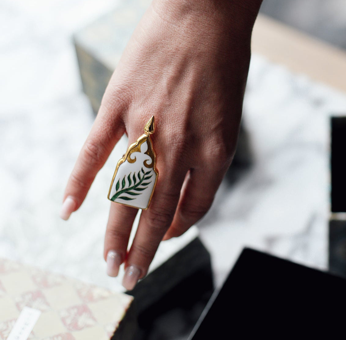 White Ring with Green Leaves