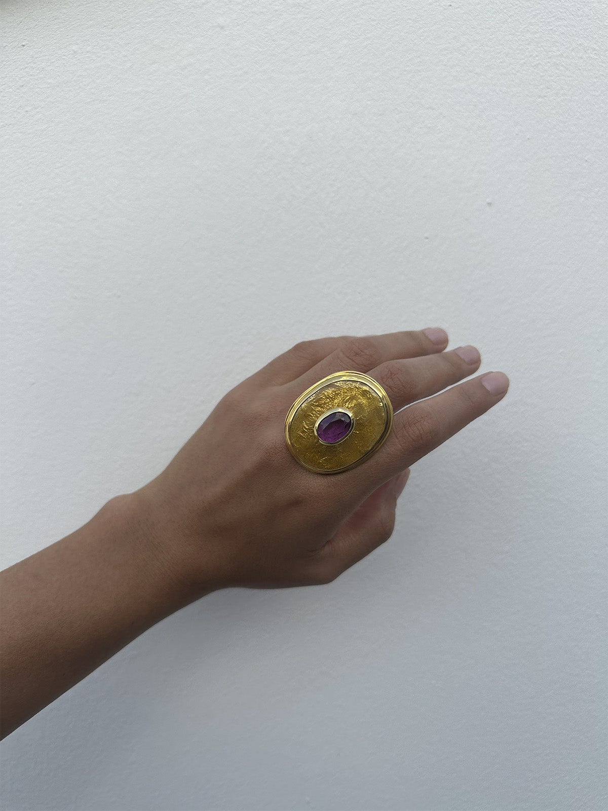 Golden ring with purple stone